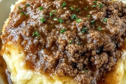 Thumbnail for Ground Beef and Gravy Over Mashed Potatoes A Classic, Comforting, and Budget-Friendly Dinner Ready in Under 30 Minutes