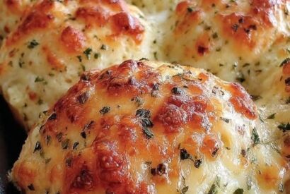 Thumbnail for Baked Garlic Butter Cheese Bombs: Gooey Mozzarella-Stuffed Biscuit Bites Brushed With Garlic Butter